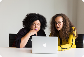 Two women working together in a modern office setting